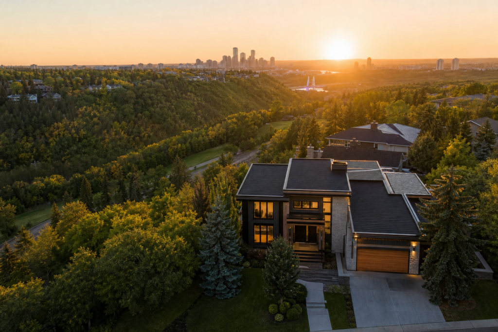 Cinematic drone view of luxury hillside home overlooking city skyline at sunset